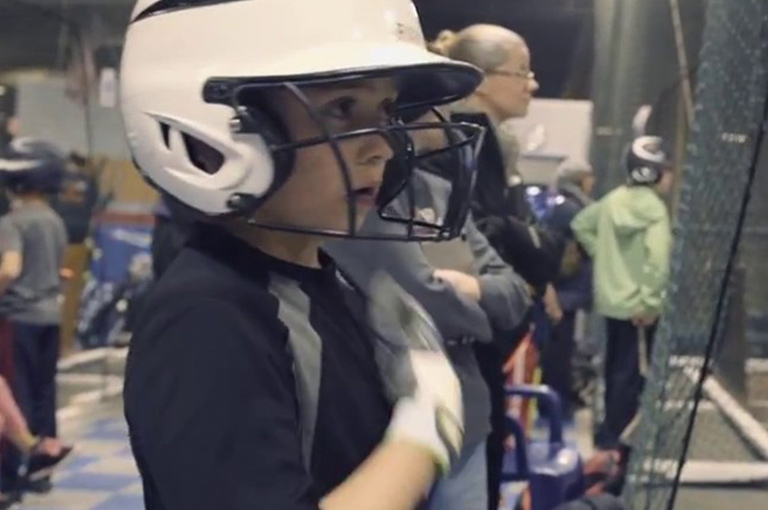 Kid wearing batting helmet