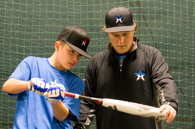 Instructor showing student how to swing