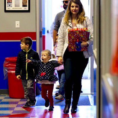 Mother and daughter walking into birthday party