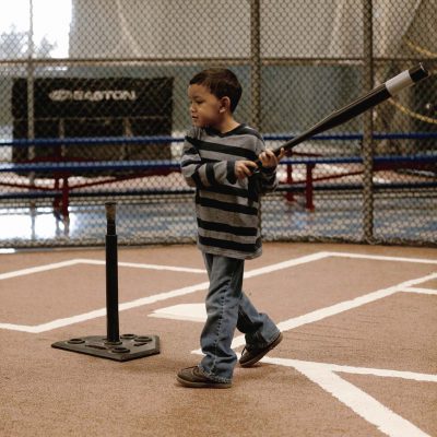 Boy swinging bat at tee-ball