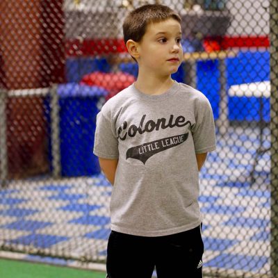 Boy standing in fenced in area