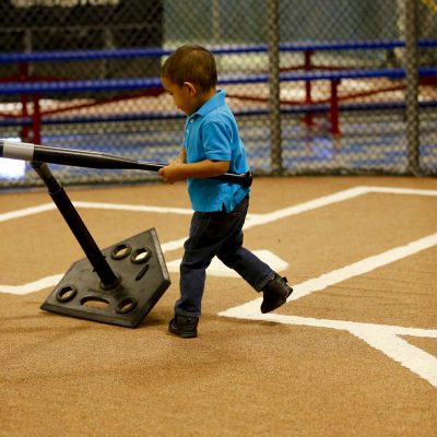 Boy hitting tee-ball