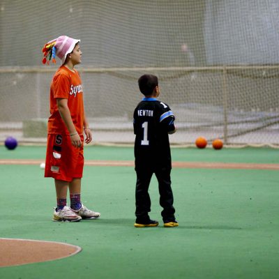 Two young kids standing in field