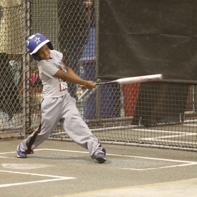 Kid up to bat mid-swing